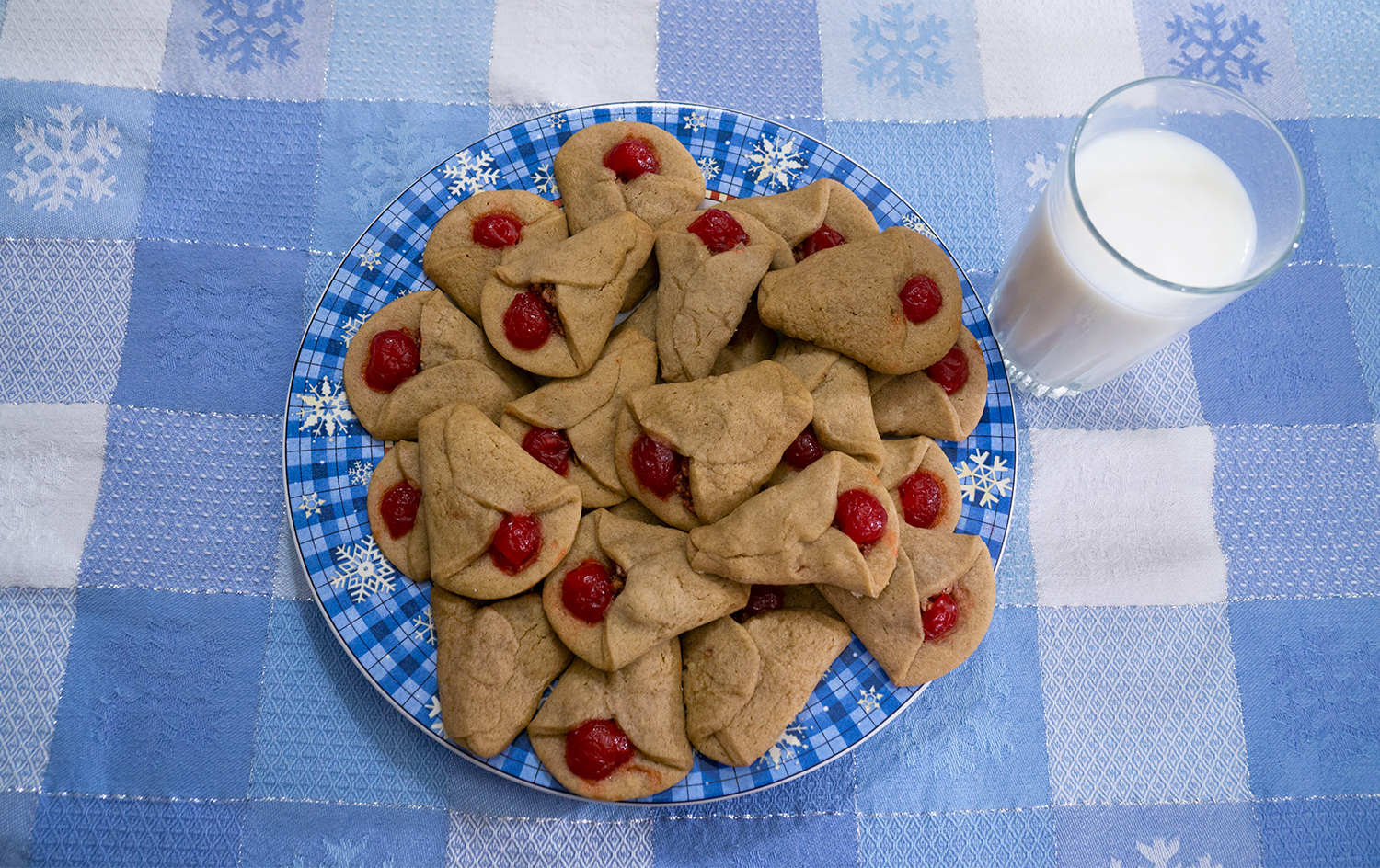 Plate full of cookies with glass of milk