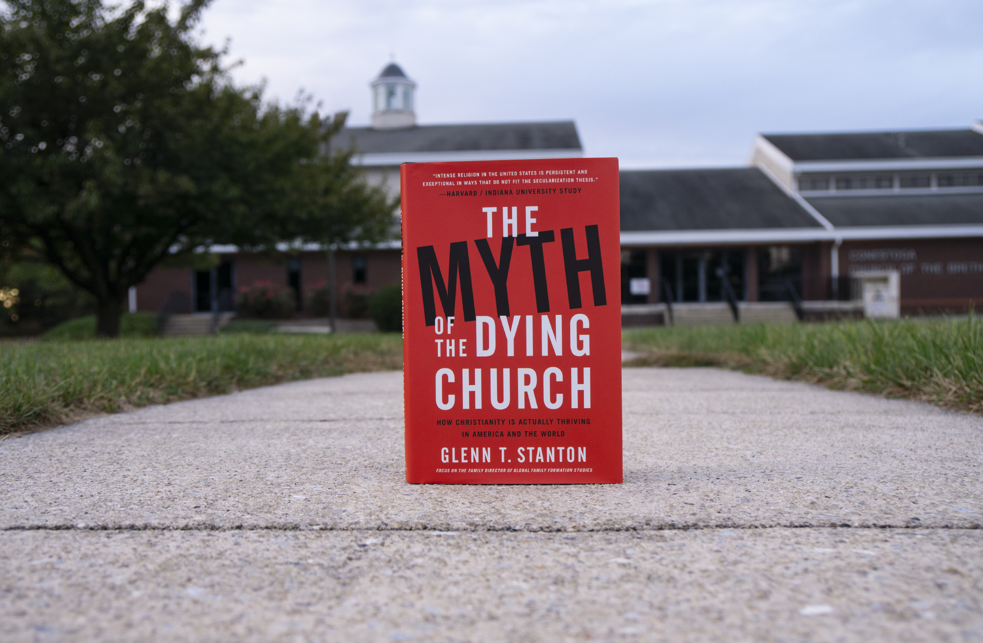 Book The Myth of the Dying Church in front of a church building